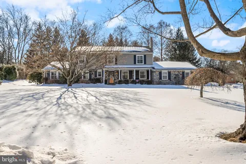 a view of a house with a snow in the yard
