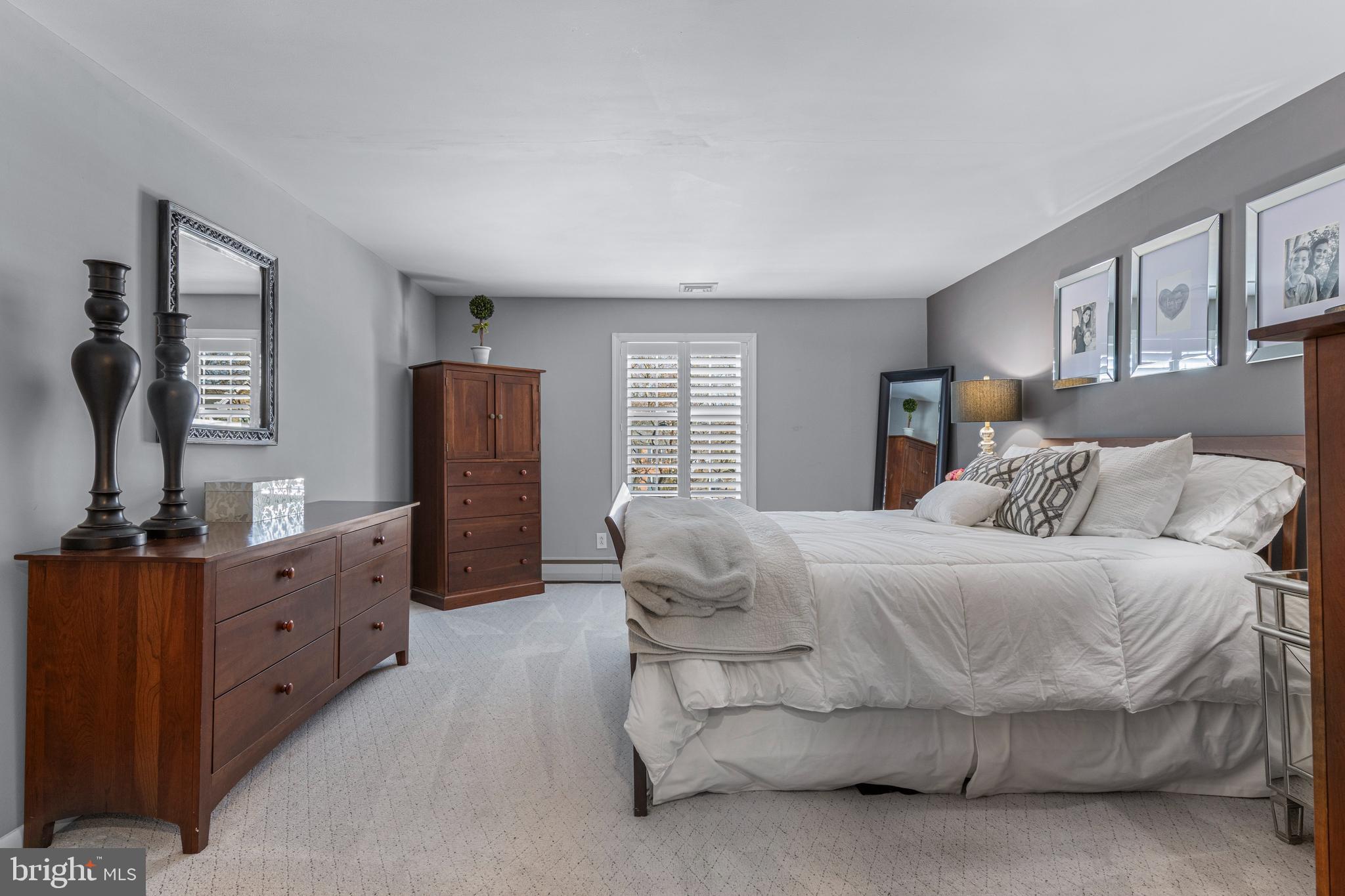 1012 Waltham Road Berwyn, PA 19312 - Photo 39 of 55 a bedroom with a bed and dresser with mirror