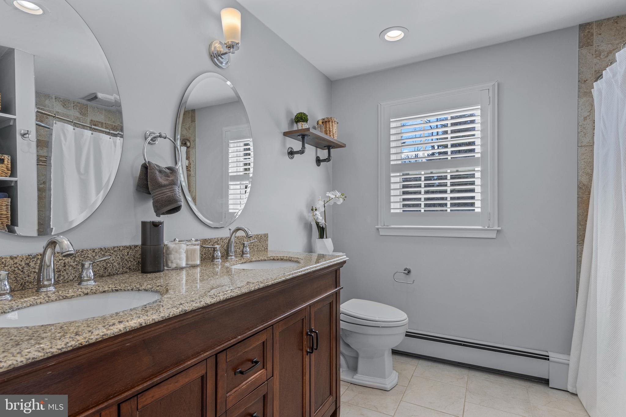 1012 Waltham Road Berwyn, PA 19312 - Photo 47 of 55 a bathroom with a granite countertop sink a toilet and a mirror