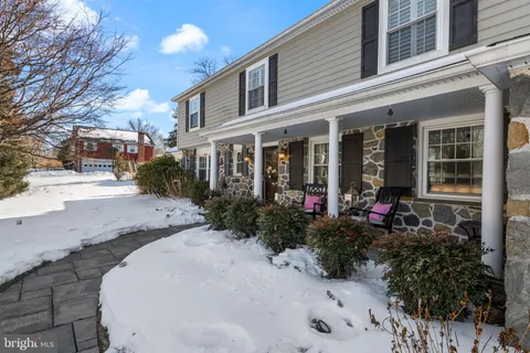 a view of a house with a small yard and pathway