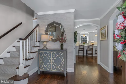 a view of a hallway with wooden floor and windows