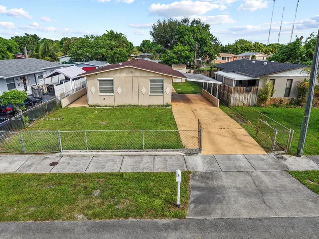 a aerial view of a house with a yard