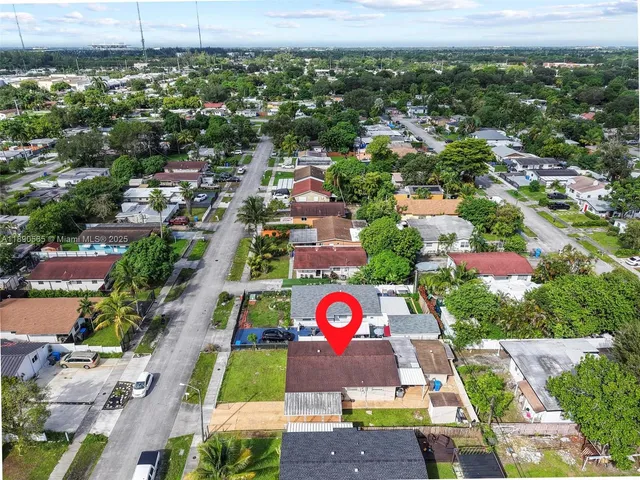 an aerial view of residential houses with outdoor space