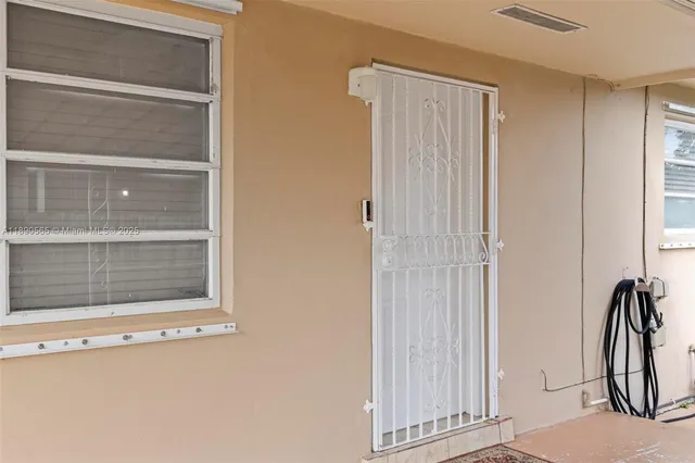 a view of a door and a window