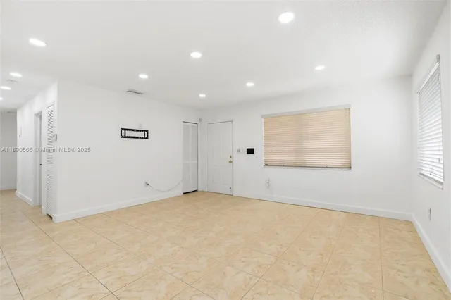 an empty room with a empty space and windows