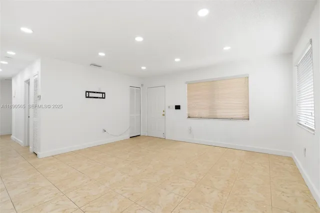 an empty room with a empty space and windows