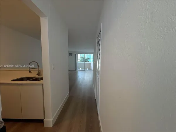 a view of a kitchen from a hallway