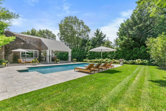 a view of a house with swimming pool and sitting area