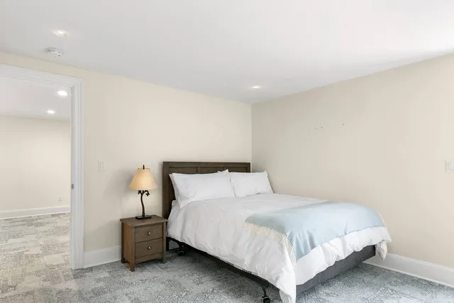 a bedroom with a bed and a night stand