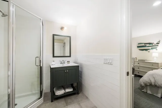 a room that has a bed and a mirror in it