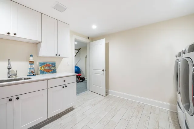a kitchen with cabinets and a refrigerator
