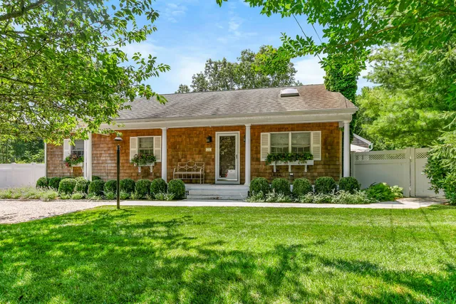 a view of a house with a yard and garden