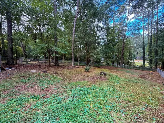 a backyard of a house with lots of green space and trees