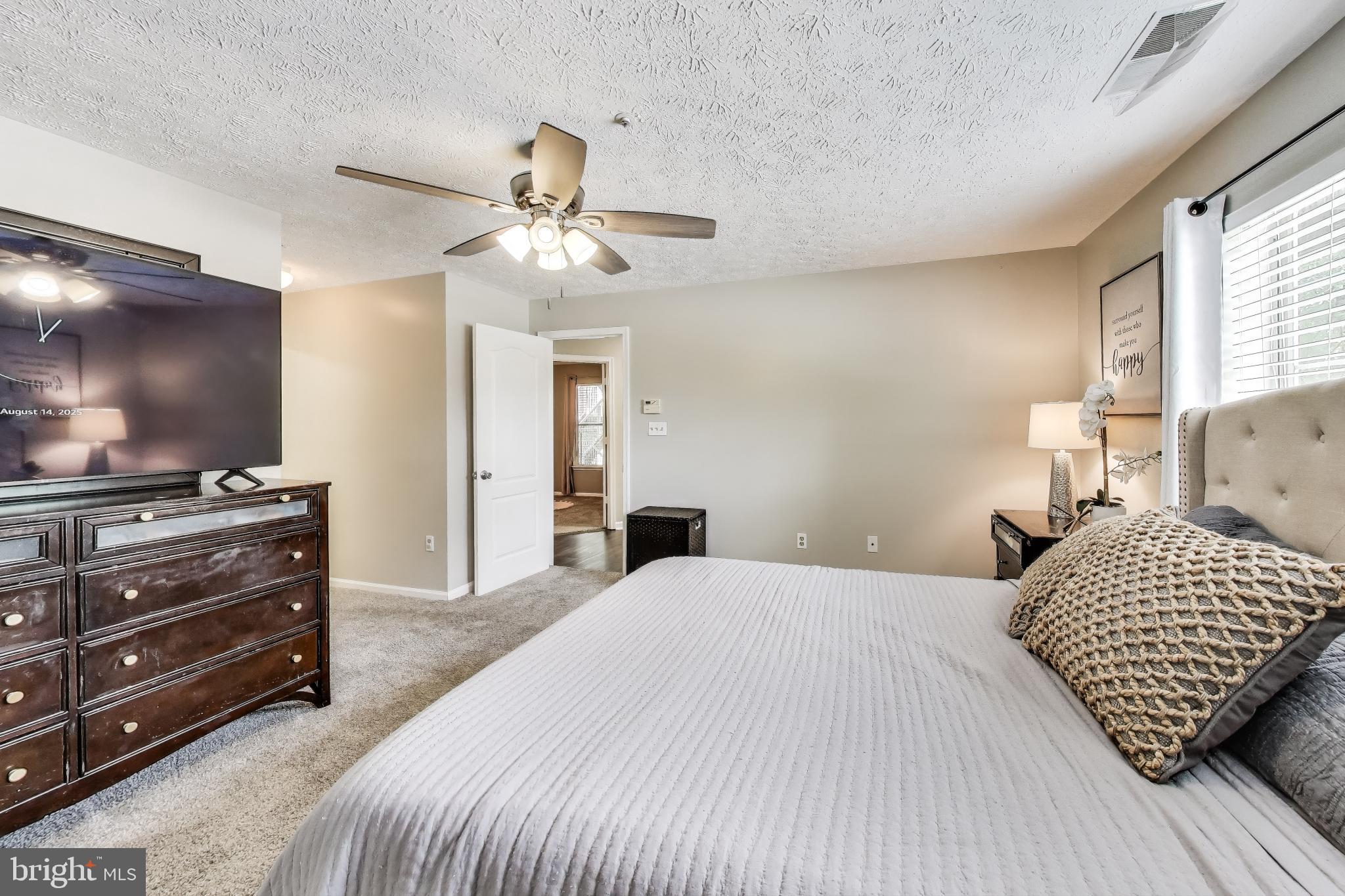 15602 Everglade Lane, Unit 2203 Bowie, MD 20716 - Photo 14 of 24 a bedroom with a bed and a flat screen tv