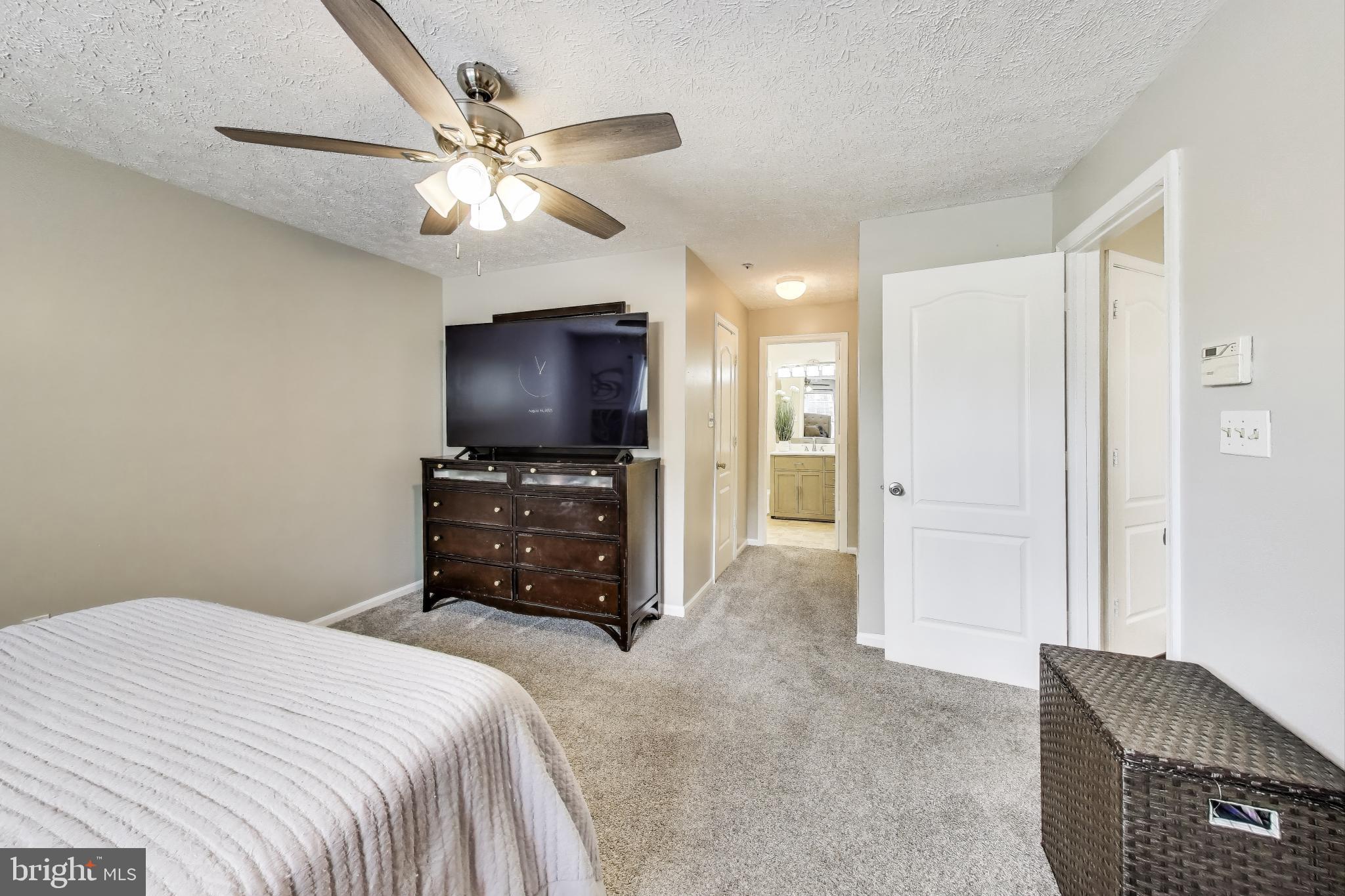 15602 Everglade Lane, Unit 2203 Bowie, MD 20716 - Photo 15 of 24 a bedroom with a bed and a flat screen tv