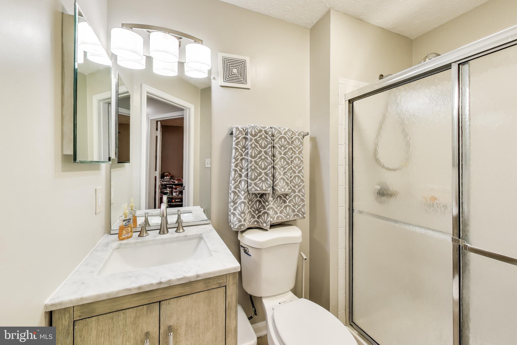 15602 Everglade Lane, Unit 2203 Bowie, MD 20716 - Photo 22 of 24 a bathroom with a sink toilet and shower