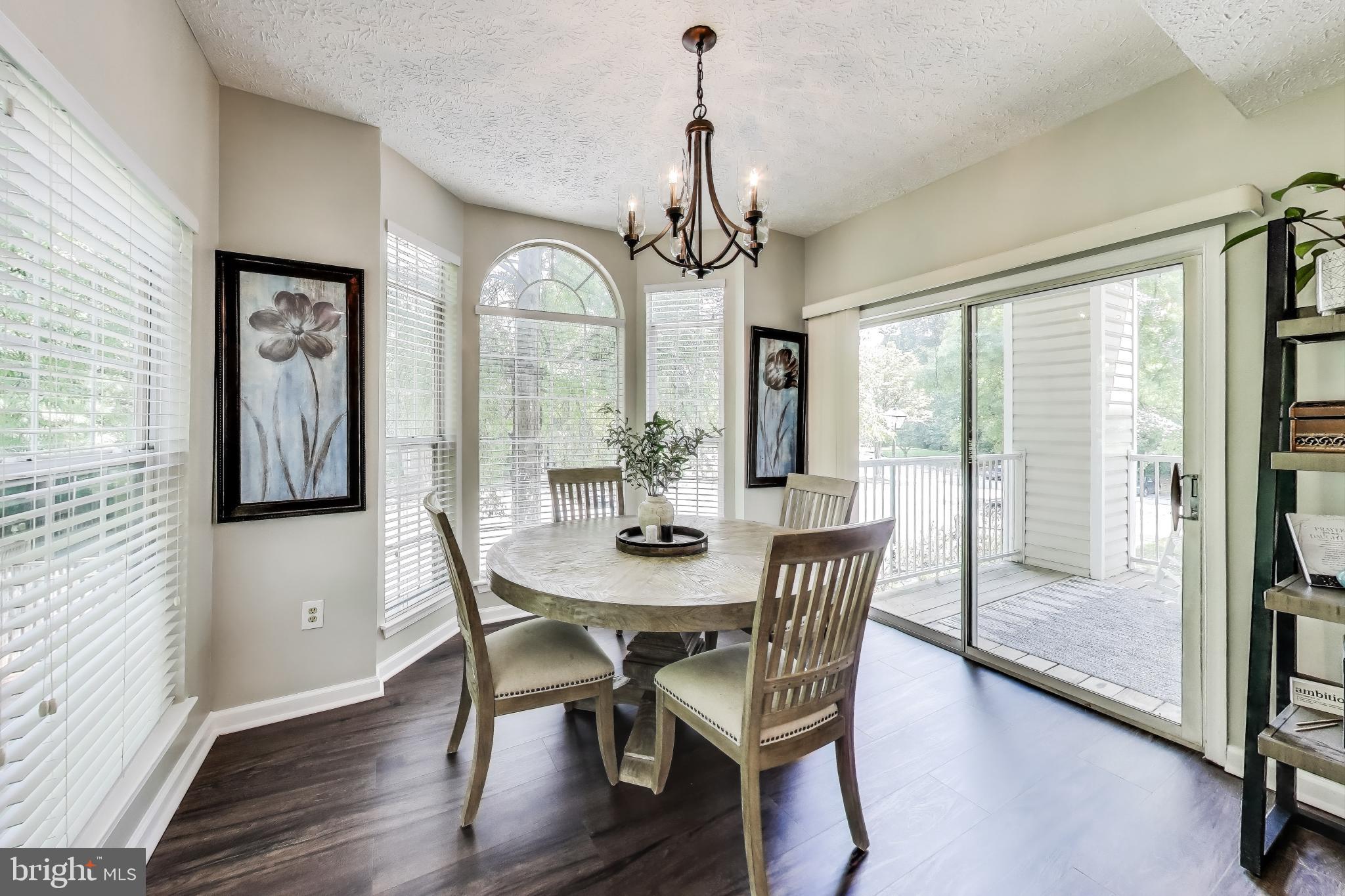 15602 Everglade Lane, Unit 2203 Bowie, MD 20716 - Photo 5 of 24 a view of a dining room with furniture window and wooden floor