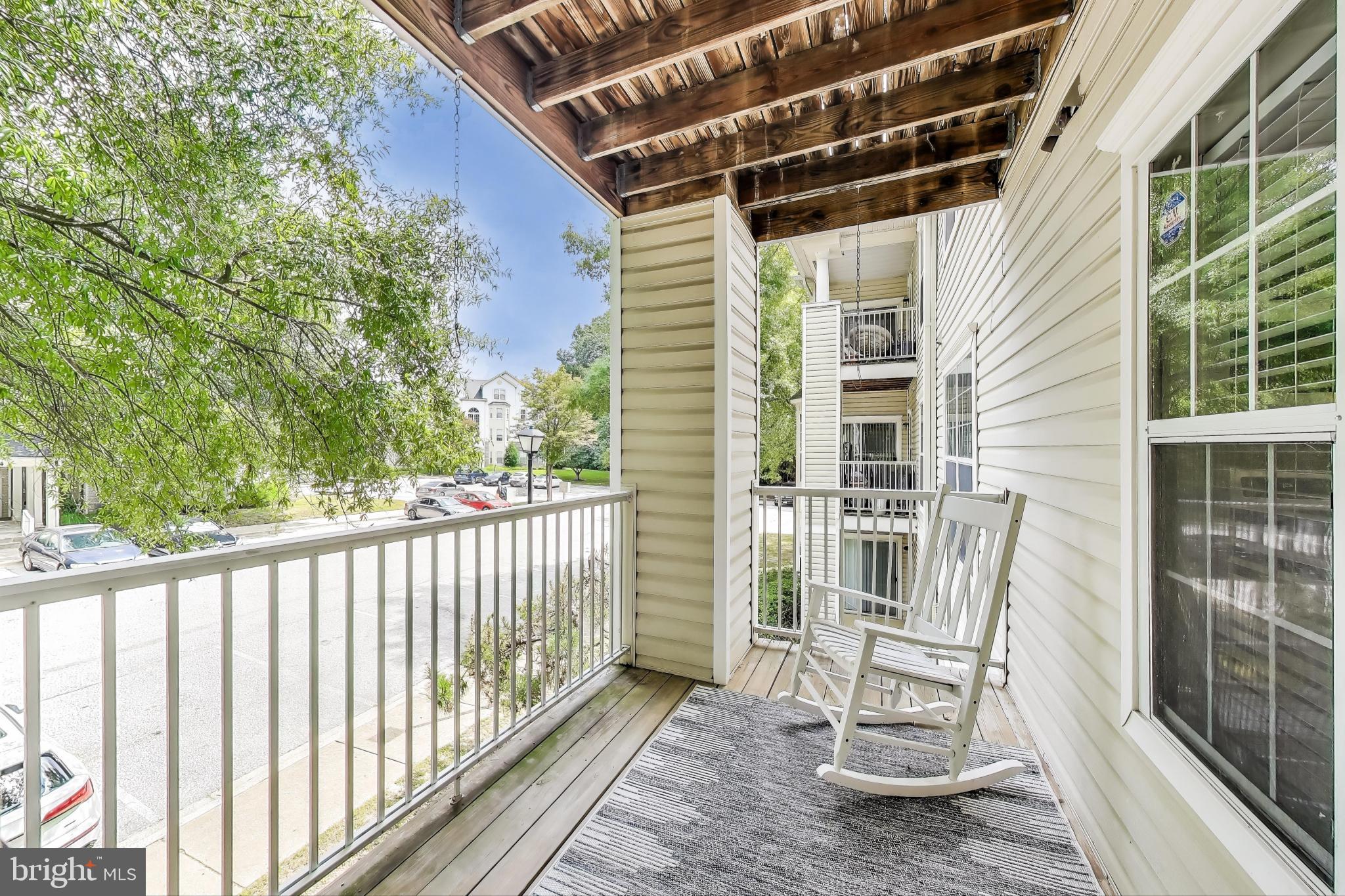 15602 Everglade Lane, Unit 2203 Bowie, MD 20716 - Photo 6 of 24 a view of balcony with two chairs and wooden fence
