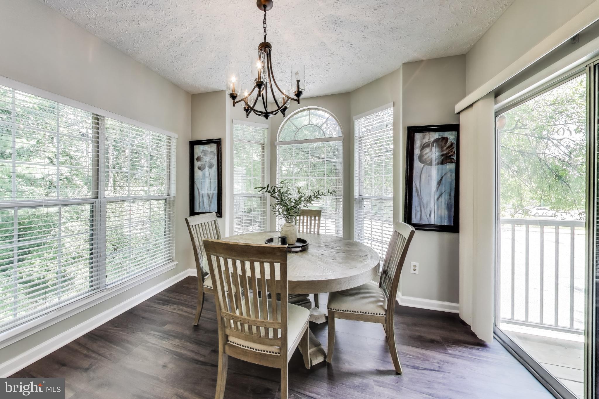 15602 Everglade Lane, Unit 2203 Bowie, MD 20716 - Photo 7 of 24 a dining room with furniture window wooden floor