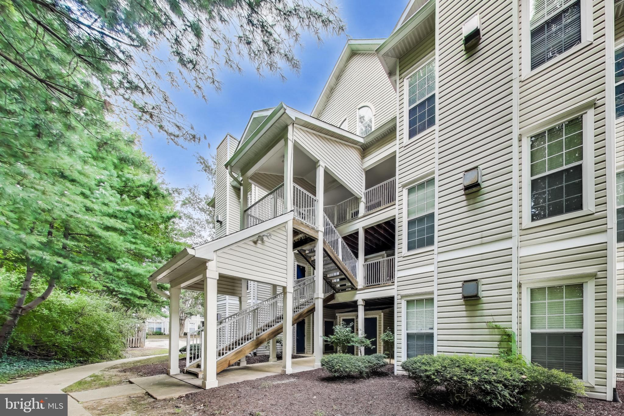15602 Everglade Lane, Unit 2203 Bowie, MD 20716 - Photo 9 of 24 a front view of a house with a yard