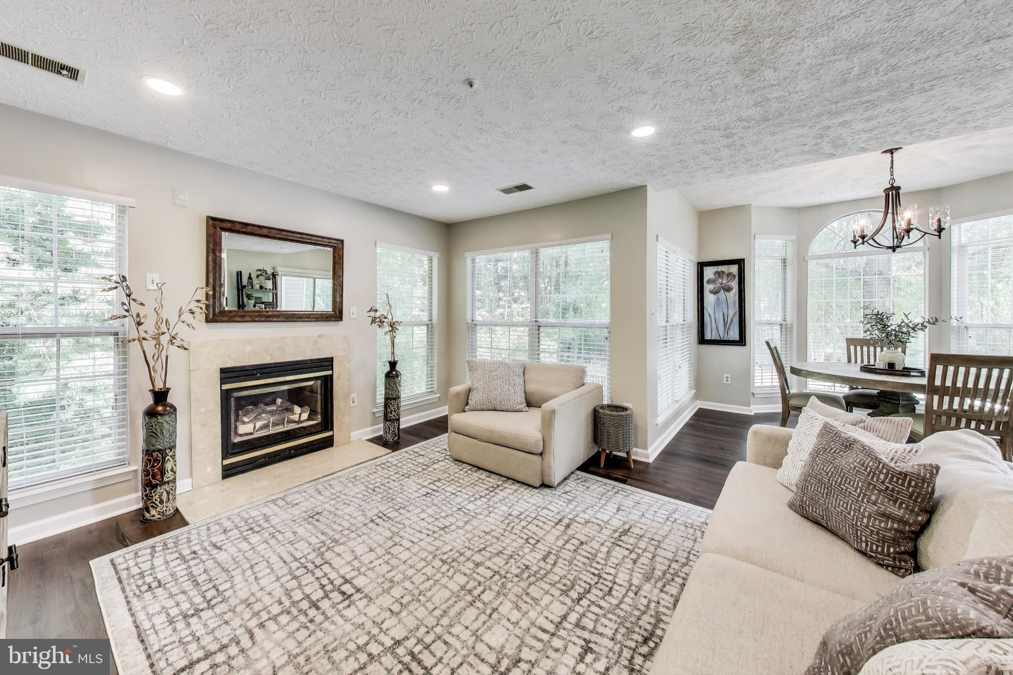 15602 Everglade Lane, Unit 2203 Bowie, MD 20716 - Photo 10 of 24 a bedroom with furniture and a fireplace