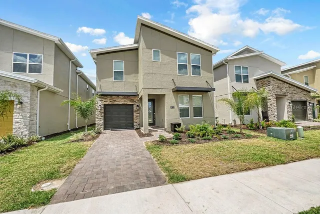 a front view of a house with garden and porch