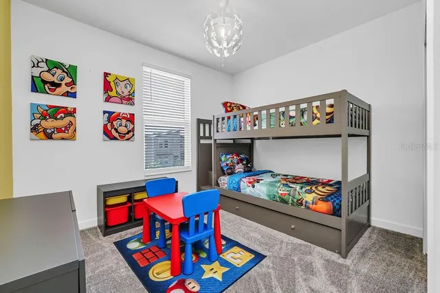 a living room with furniture and a baby couch