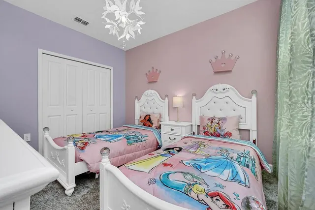 a bedroom with bed and two windows