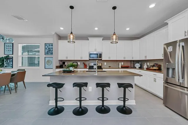 a kitchen with counter space appliances cabinets and furniture