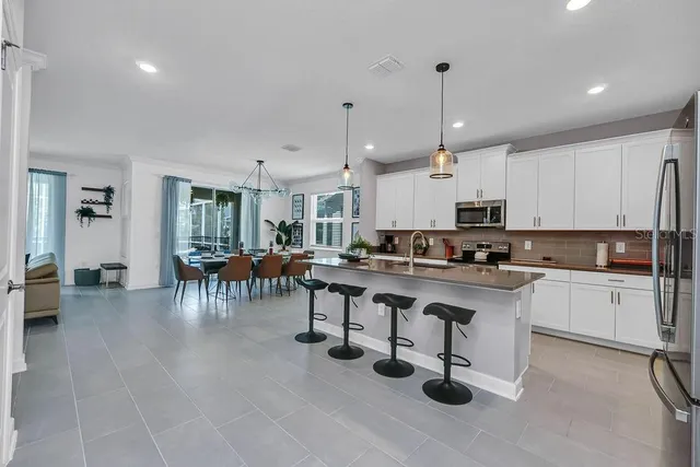 a living room with stainless steel appliances kitchen island granite countertop furniture and a kitchen view