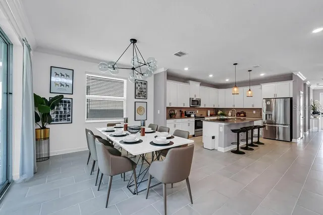 a dining room with furniture window and wooden floor