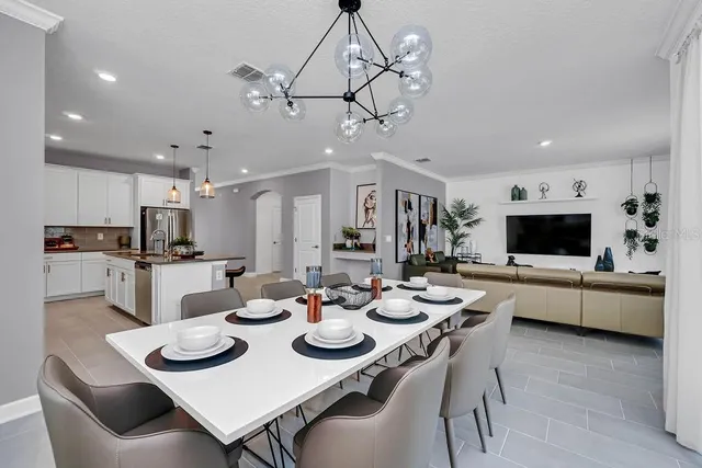 a view of a dining room and kitchen with furniture and a kitchen view