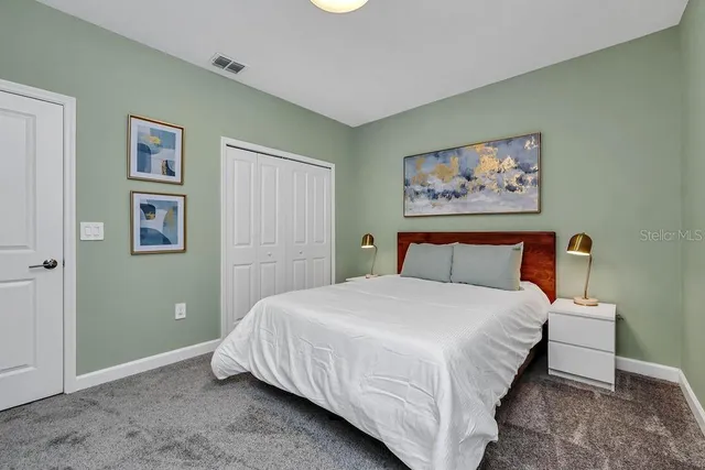 a bedroom with a bed and wall painting