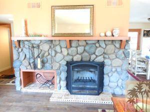 25740 Saunders Meadow Road Idyllwild, CA 92549 - Photo 3 of 16 a wooden floor with a table and a fireplace