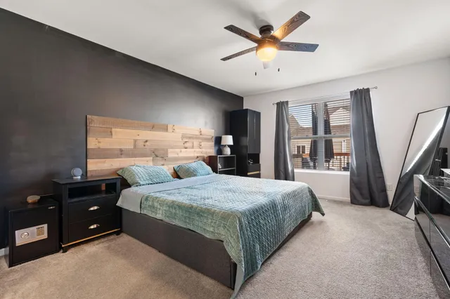 a bedroom with a large bed and a tv