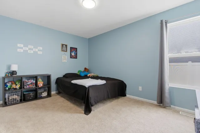 a bedroom with a bed and a tv on the dresser