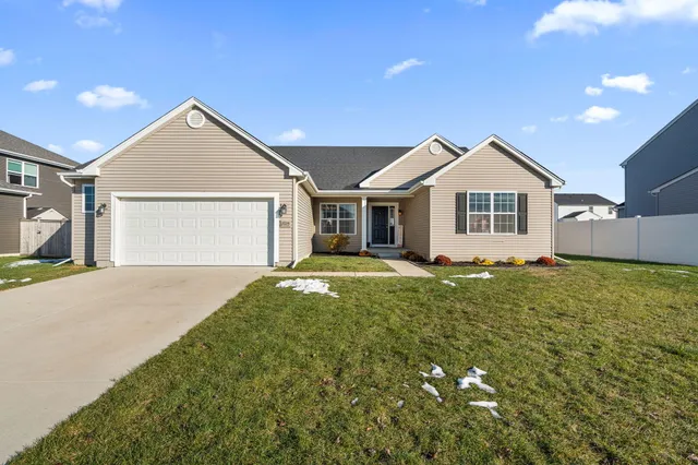 a view of a house with a yard and garage