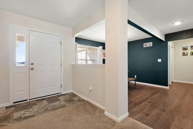 an empty room with windows and closet