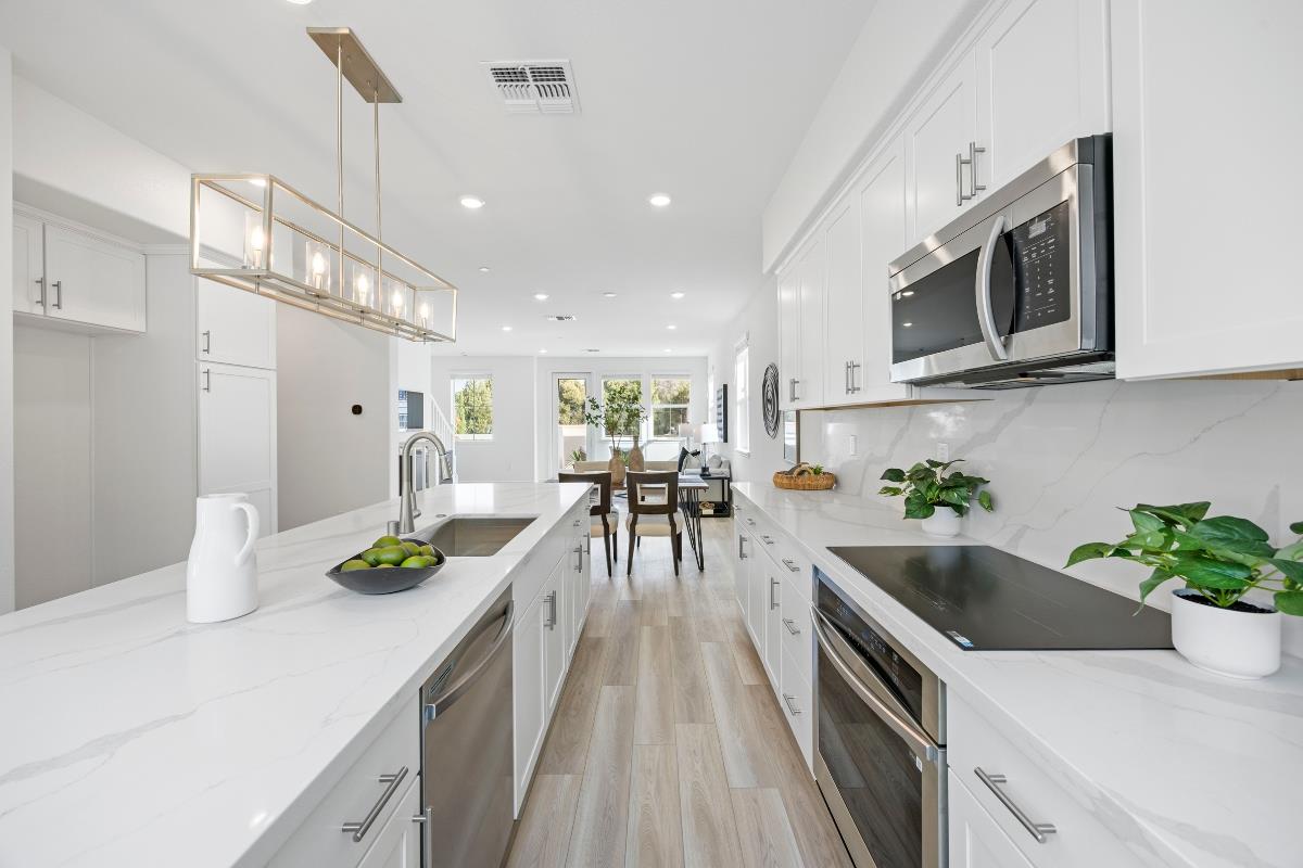 3775 Castro Valley Boulevard Castro Valley, CA 94546 - Photo 15 of 35 a kitchen with stainless steel appliances kitchen island granite countertop a sink a stove and cabinets