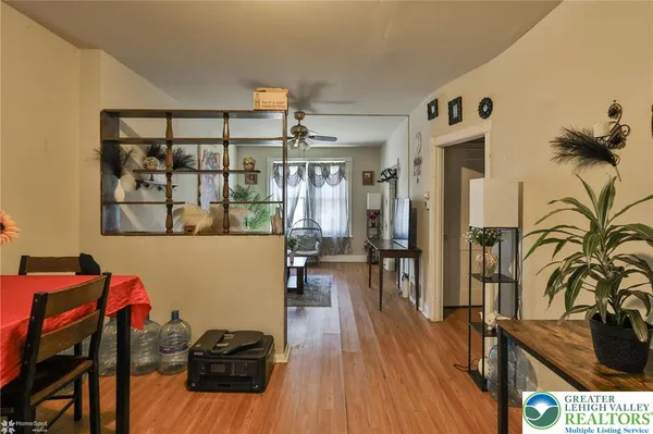 a dining room with furniture and wooden floor