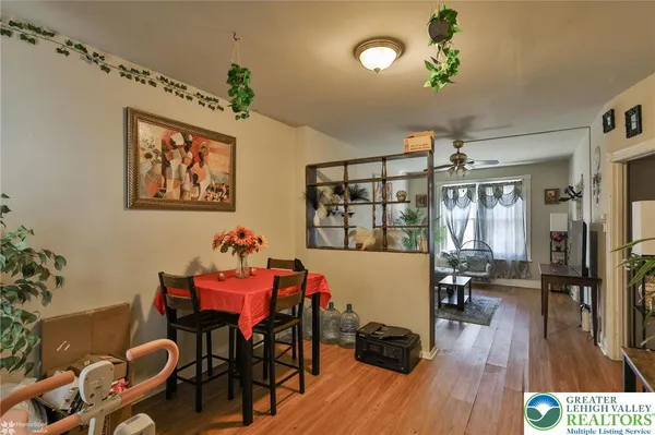 a kitchen with stainless steel appliances a sink a refrigerator a counter space and a window