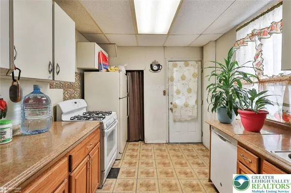 a kitchen with refrigerator a sink and cabinets