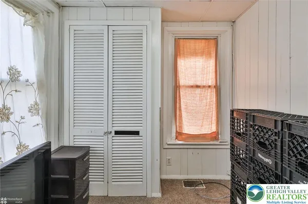 a view of walk in closet with clothes