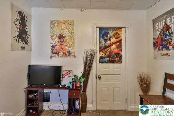 a bedroom with a bed and a painting on the wall