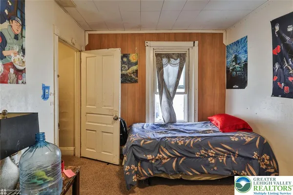 a bed sitting in a bedroom next to a window