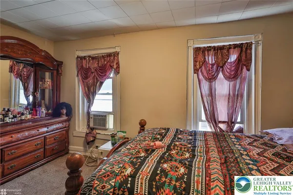 a bed room with a bed and a window