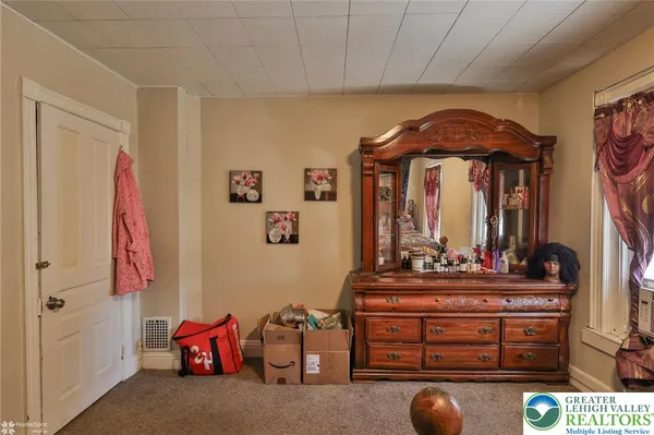 a room with gym equipment and a rug