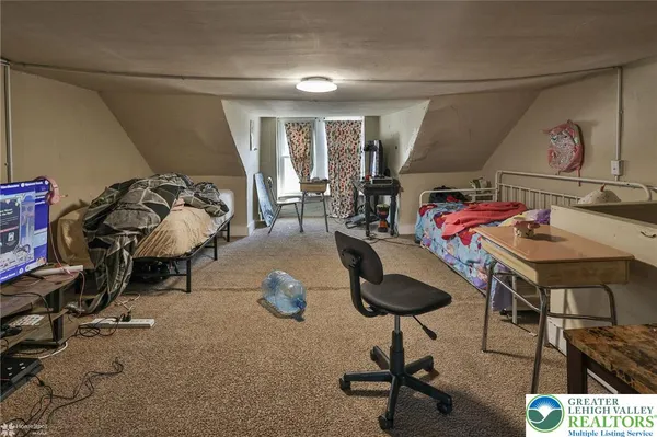 a bedroom with furniture and a chair