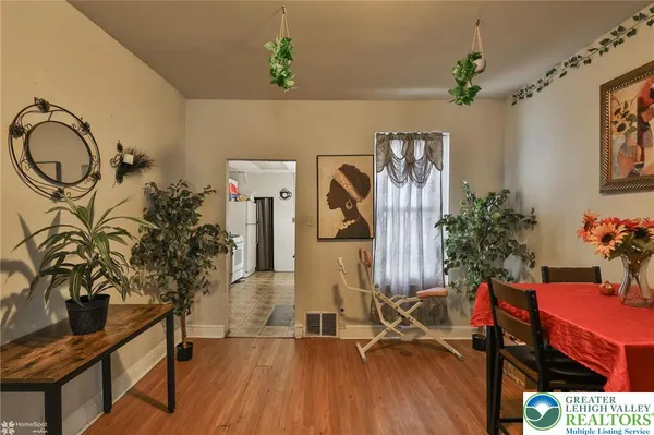 a dining room with furniture and wooden floor