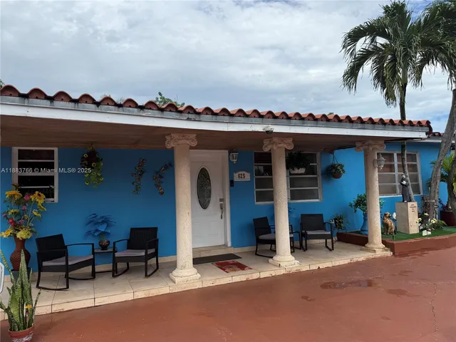 a view of a patio with a dining table and chairs